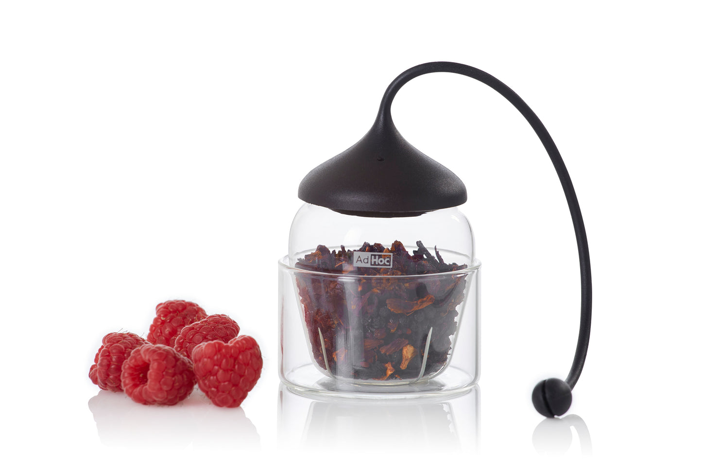 Glas-Teefilter Fusion von AdHoc mit schwarzem Deckel steht neben Himbeeren.
