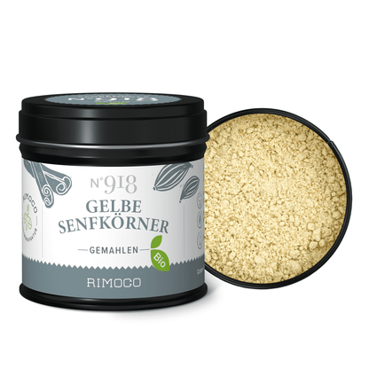 Geöffnete schwarze Dose mit gemahlenen gelben Senfkörnern sichtbar im Inneren.
