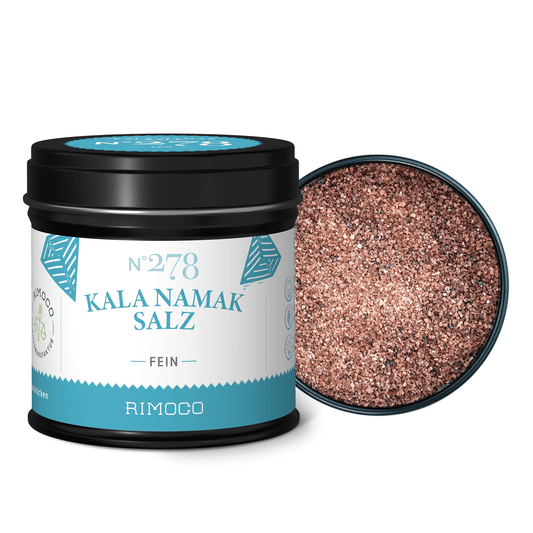 Dose Kala Namak Salz neben offener Dose mit rosa-braunem grobem Salz für vegane Küche.