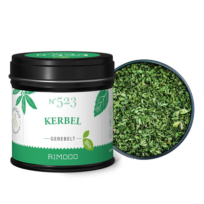 Schwarze Dose Bio Kerbel, daneben gehackte, getrocknete Kräuter und etwas Kraut verstreut.