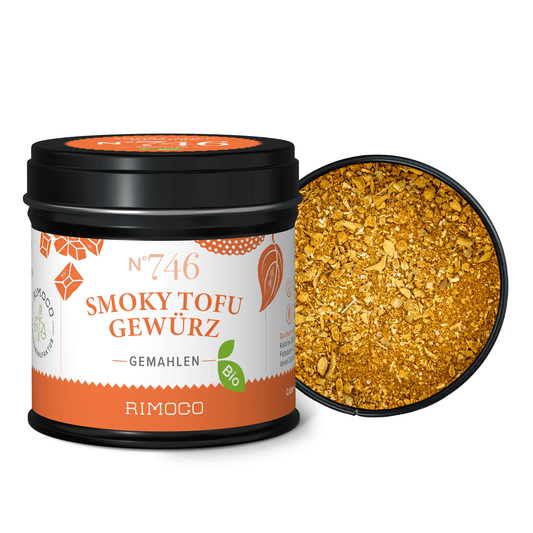 Geöffnete Dose mit orangefarbenem Bio Smoky Tofu Gewürz und sichtbarem Paprikapulver.